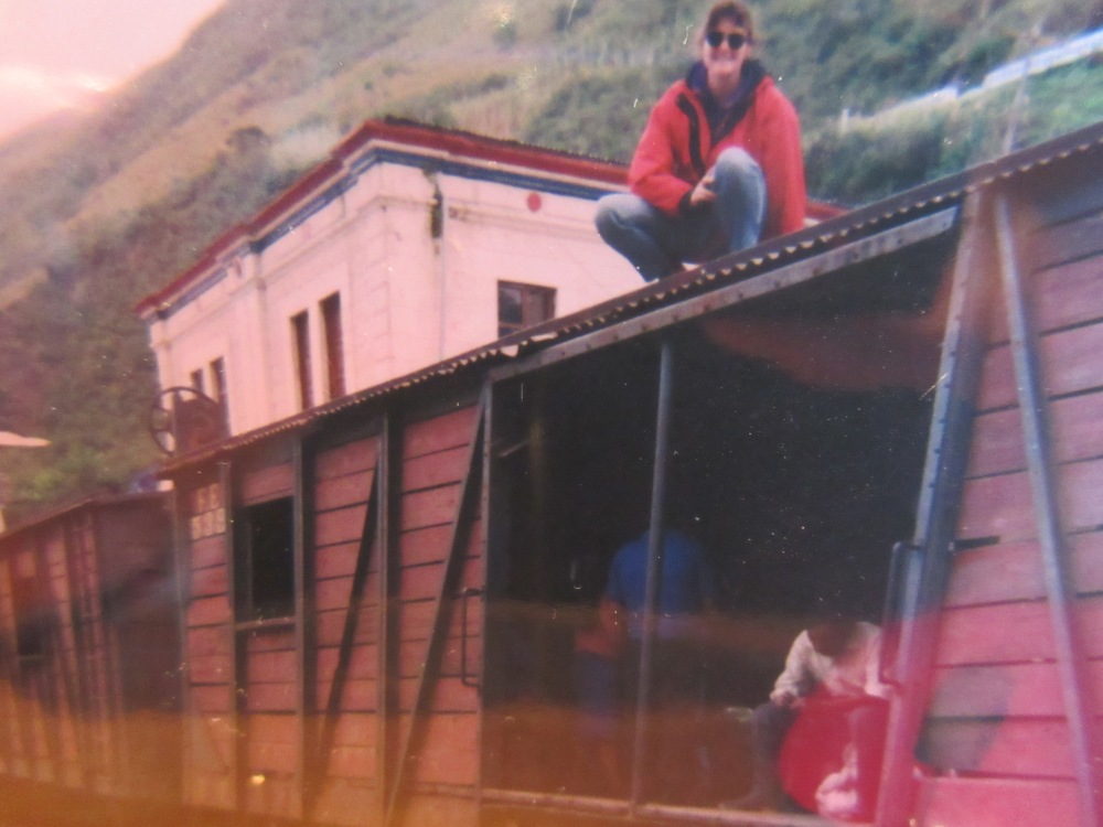 That is me, in my favourite red jacket, riding on top of the train in Ecuador. 